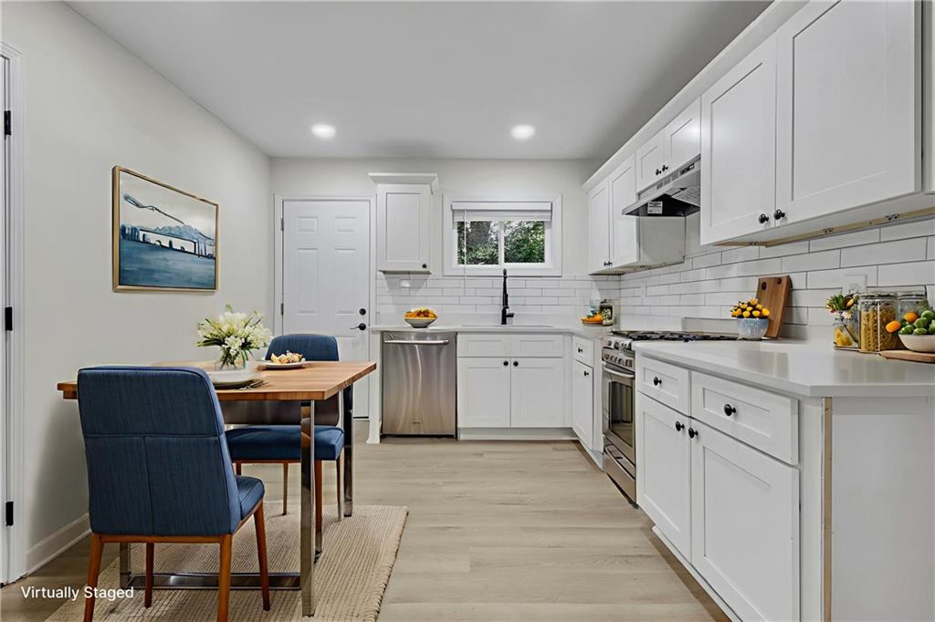 3531 Tulip Drive Decatur, GA 30032 - Photo 7 of 48 a kitchen with a table chairs sink and cabinets