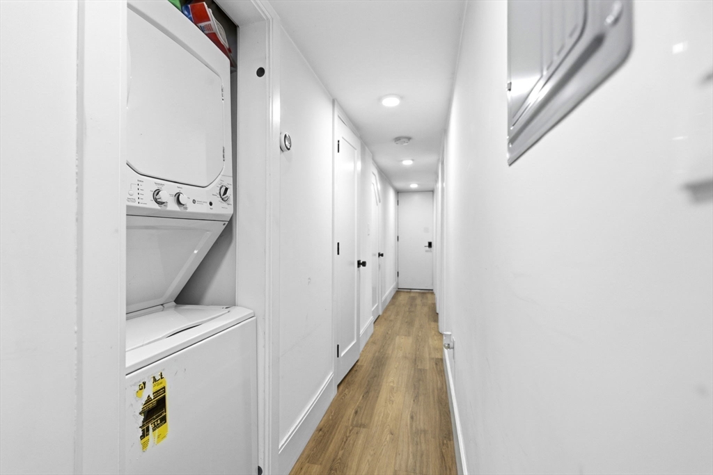 92 Chelsea Street, Unit 1 Boston, MA 02128 - Photo 11 of 14 a view of a hallway with washer and dryer