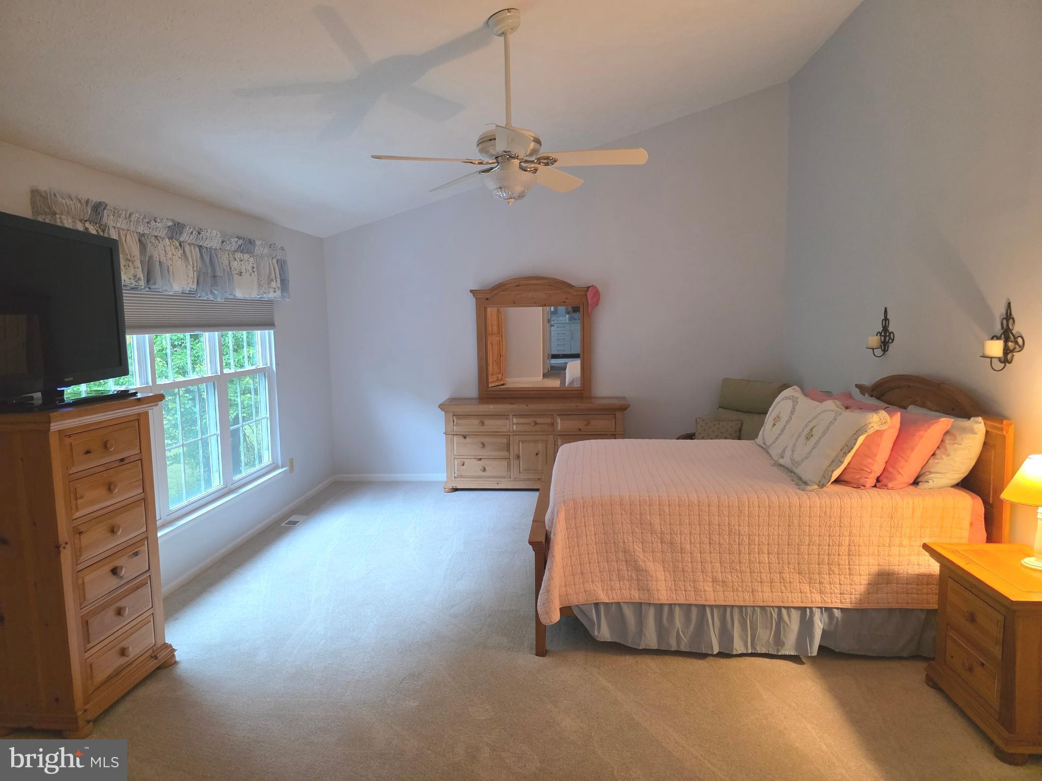 2441 Kemper Road Crofton, MD 21114 - Photo 42 of 63 a bedroom with a bed and a flat tv screen on dresser
