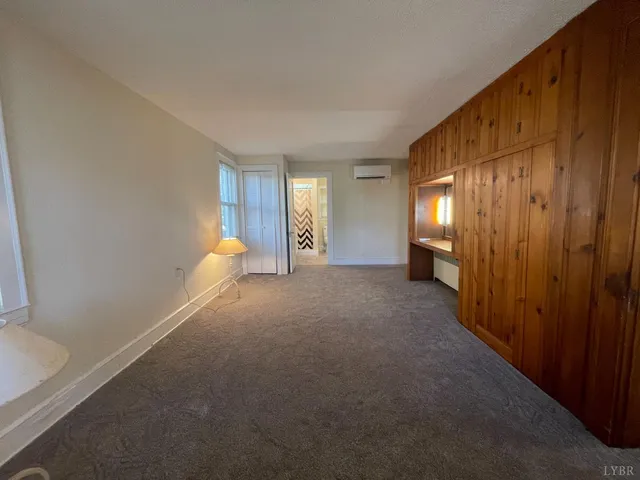 a view of an empty room with a fireplace
