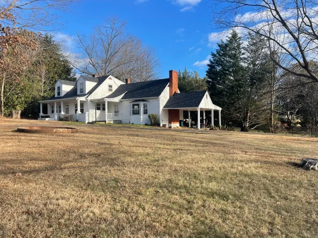 a view of a house with yard and sitting area