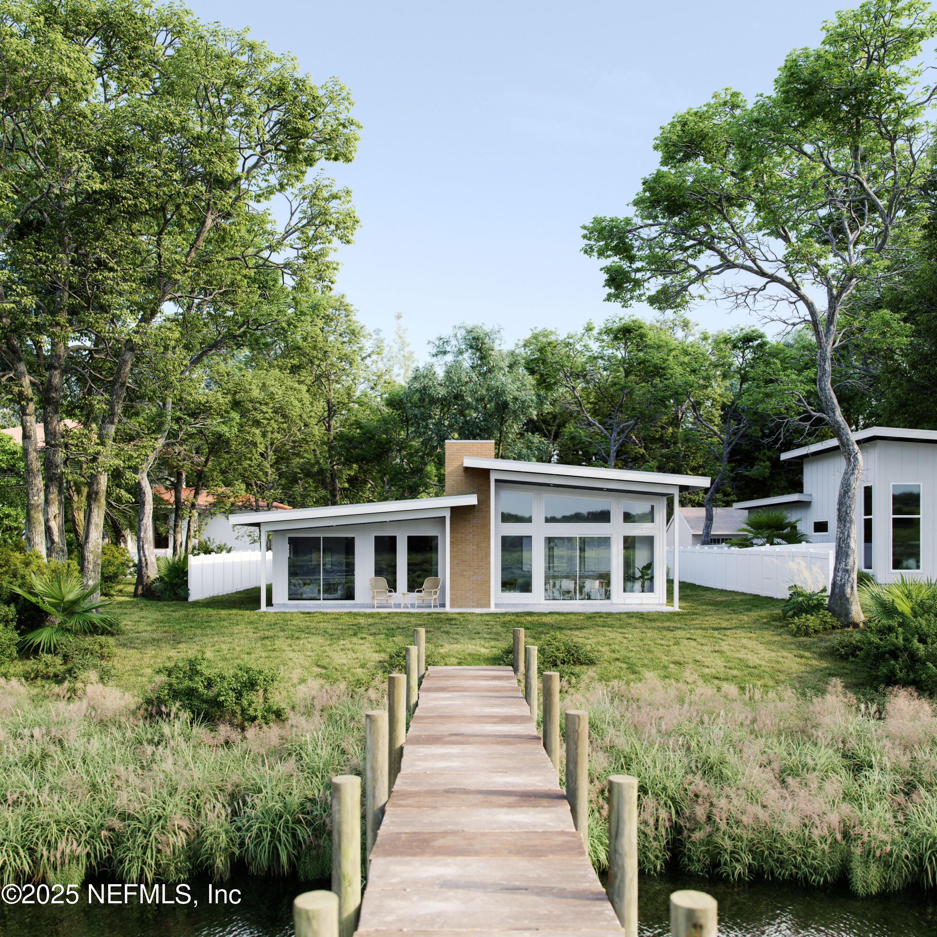 22 Poinciana Cove Road St. Augustine, FL 32084 - Photo 20 of 20 a front view of a house with a garden and trees