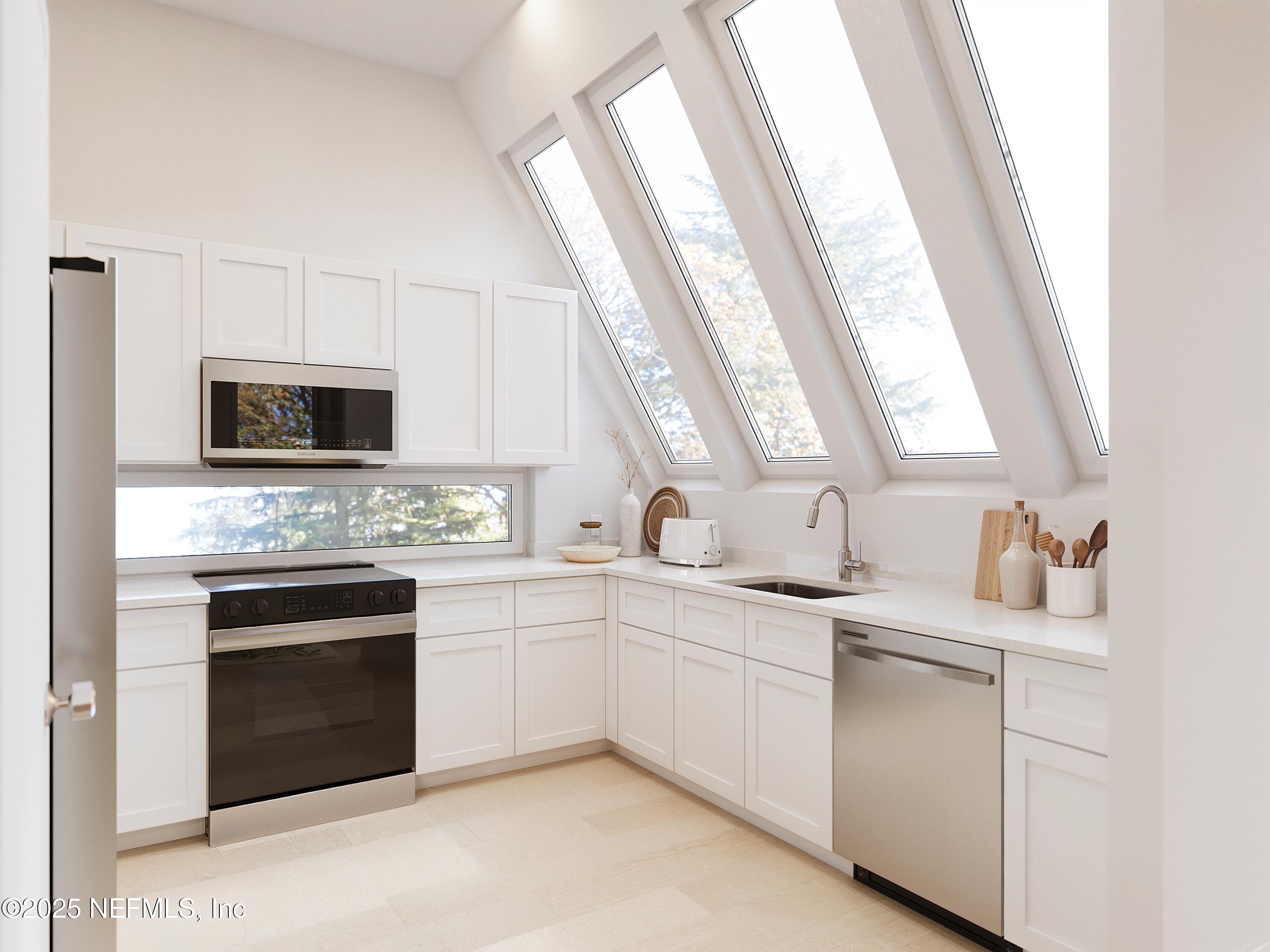 22 Poinciana Cove Road St. Augustine, FL 32084 - Photo 6 of 20 a kitchen with white cabinets appliances and sink