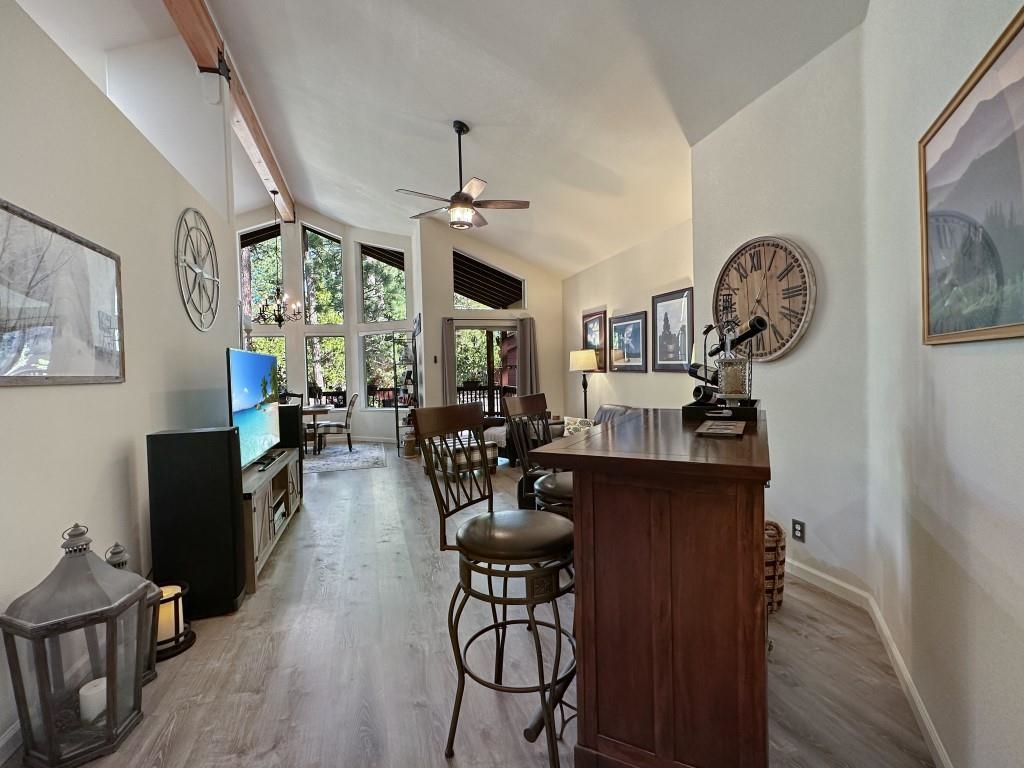 27 One Horse Way Clio, CA 96106 - Photo 12 of 38 a view of dining room and livingroom with furniture wooden floor a chandelier