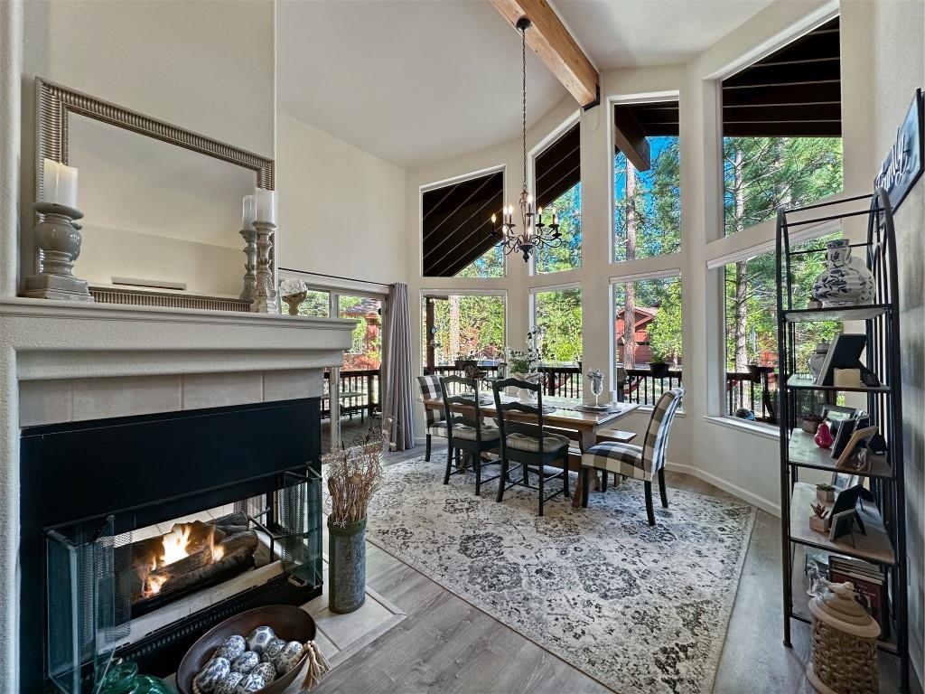 27 One Horse Way Clio, CA 96106 - Photo 13 of 38 a living room with furniture a fireplace a flat screen tv and a large window