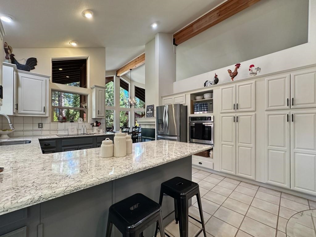27 One Horse Way Clio, CA 96106 - Photo 8 of 38 a kitchen with stainless steel appliances kitchen island granite countertop a sink and cabinets
