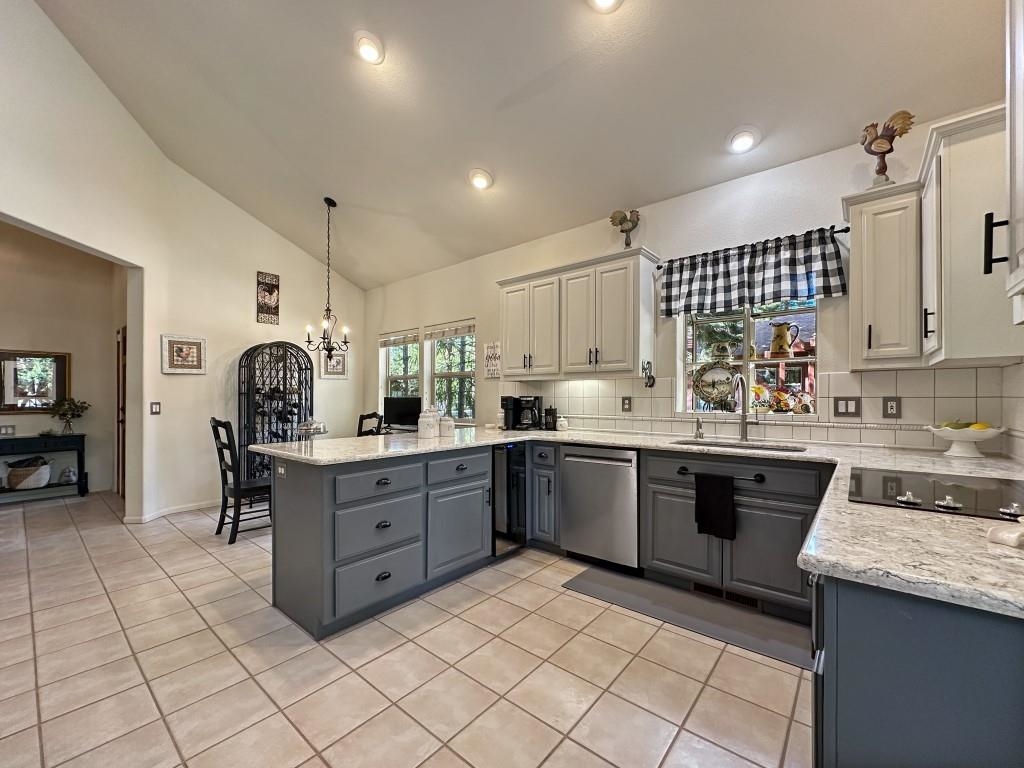 27 One Horse Way Clio, CA 96106 - Photo 10 of 38 a kitchen with a sink window and cabinets