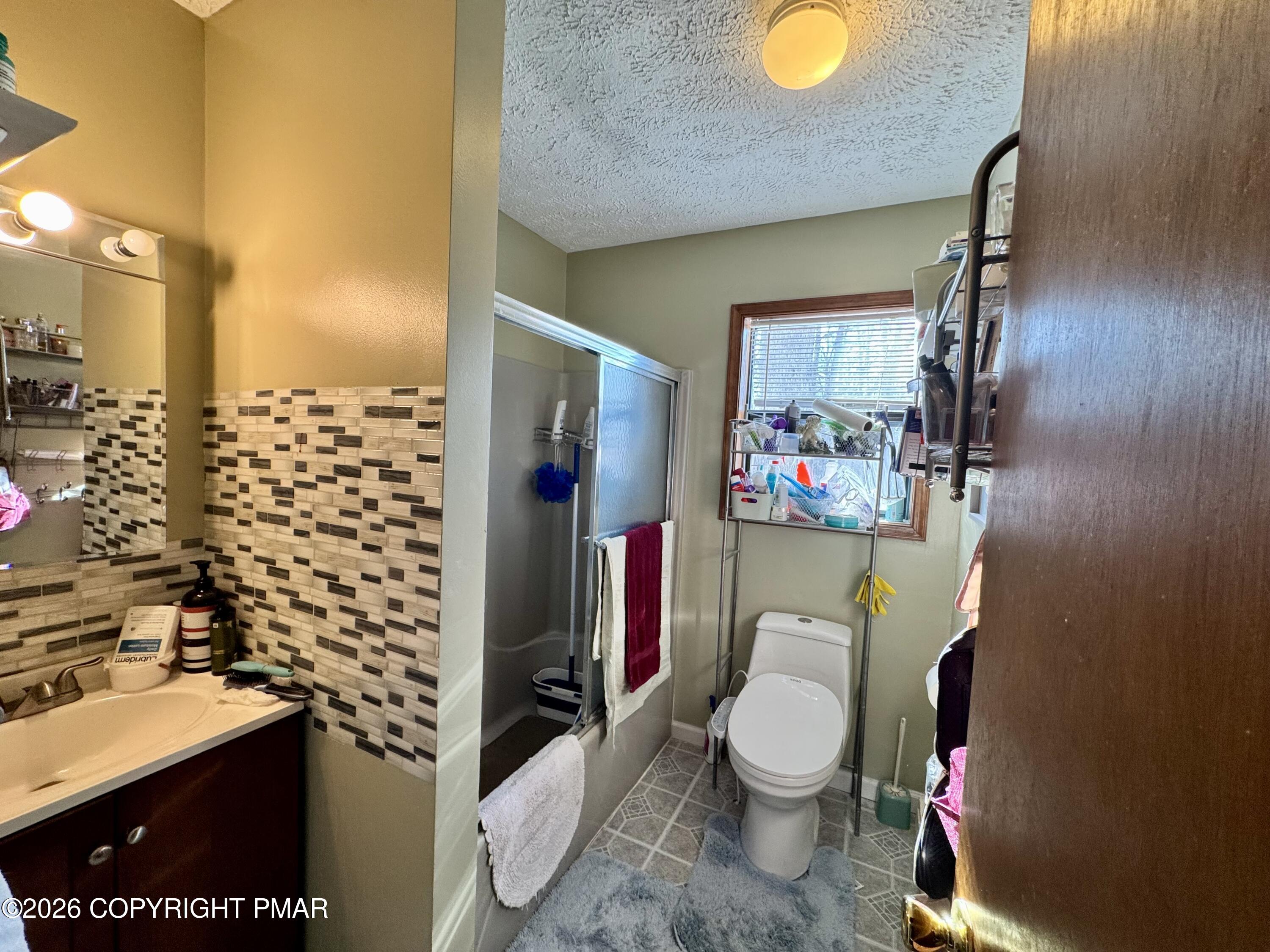 217 Bindale Road Tamiment, PA 18371 - Photo 12 of 27 a bathroom with a toilet a sink and a shower