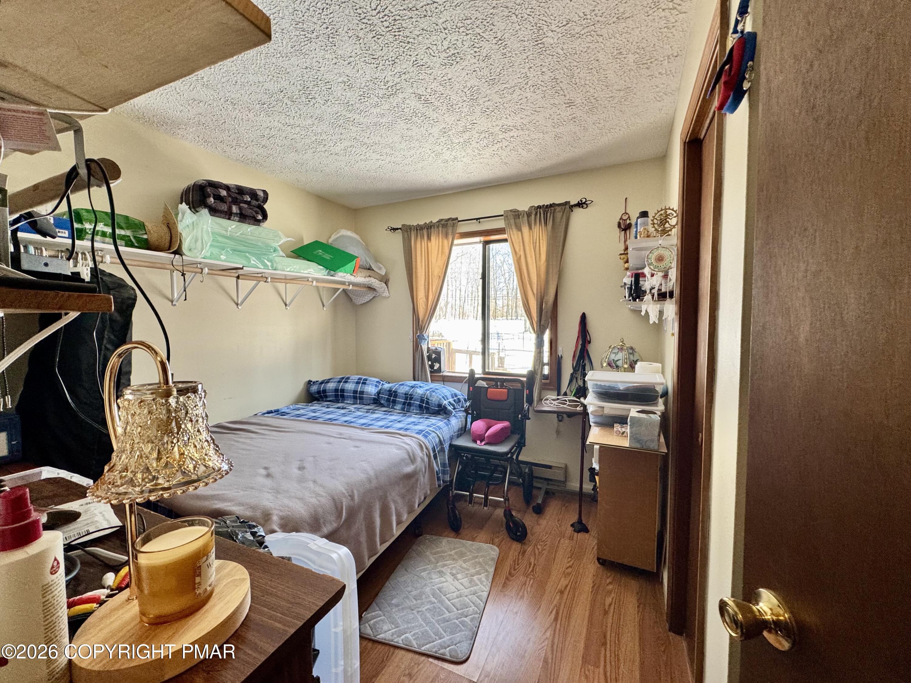 217 Bindale Road Tamiment, PA 18371 - Photo 18 of 27 a bedroom with furniture and a wooden floor