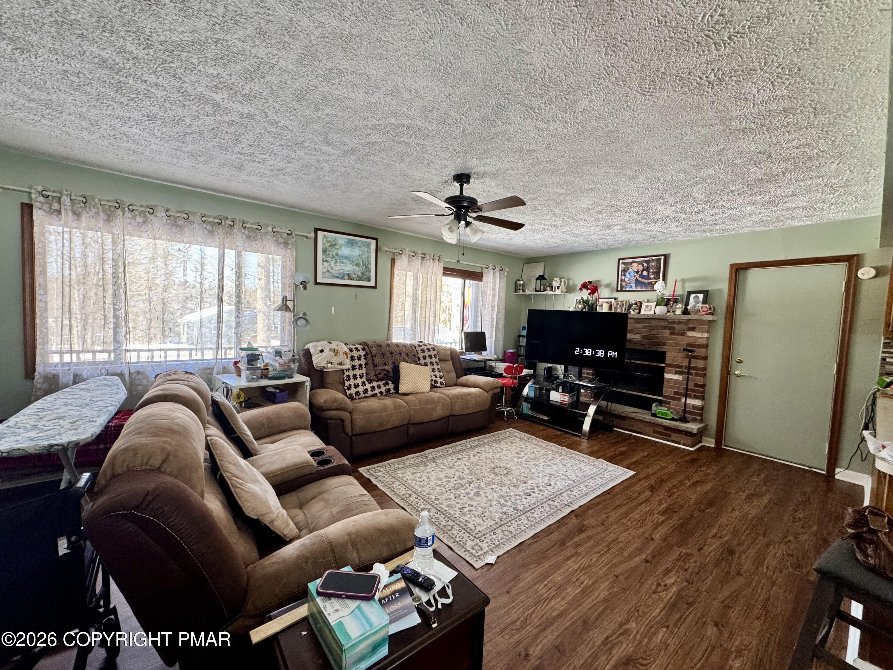 217 Bindale Road Tamiment, PA 18371 - Photo 2 of 27 a living room with furniture and a fireplace