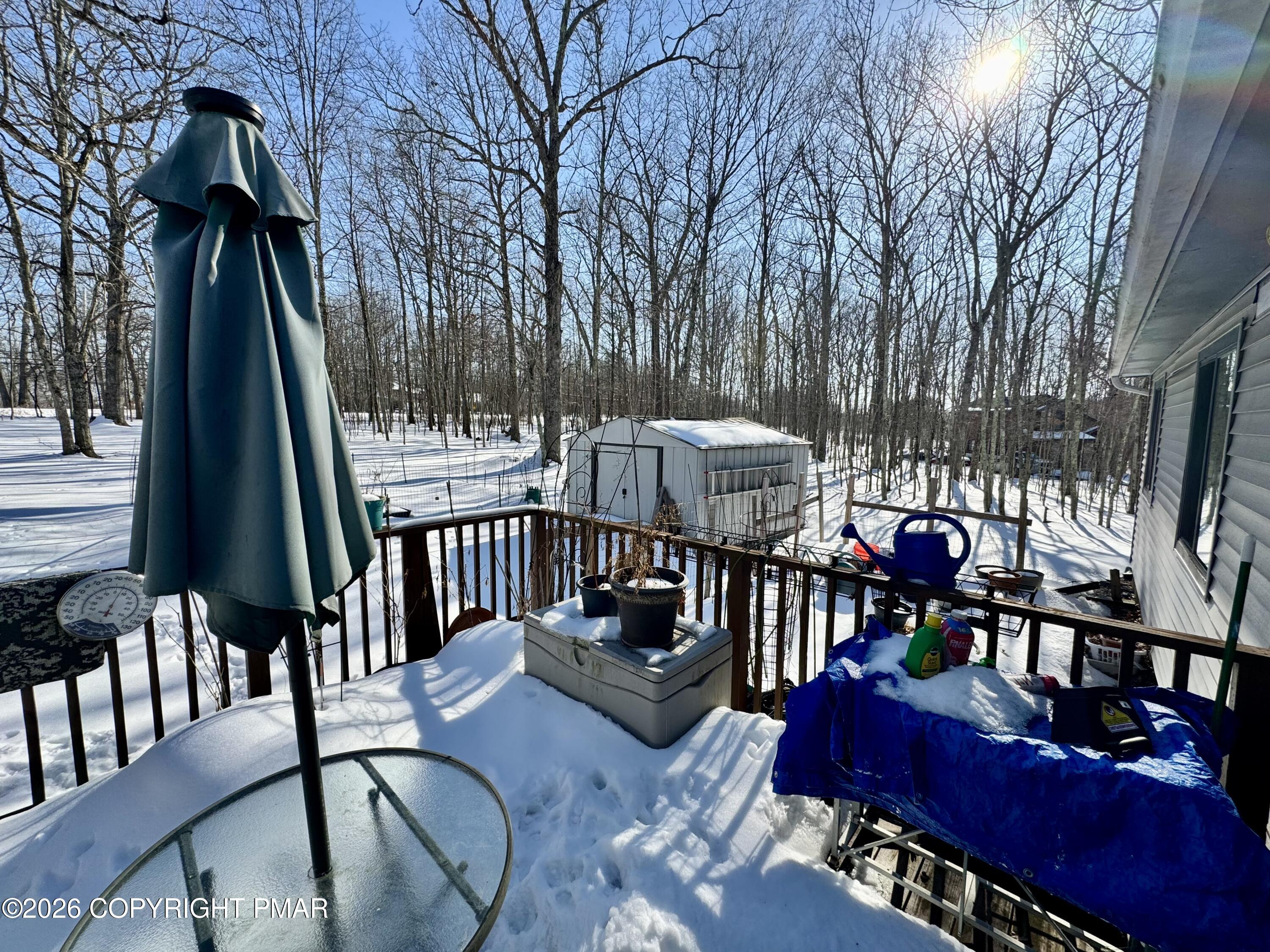 217 Bindale Road Tamiment, PA 18371 - Photo 26 of 27 a view of a patio with couches table and chairs and wooden fence
