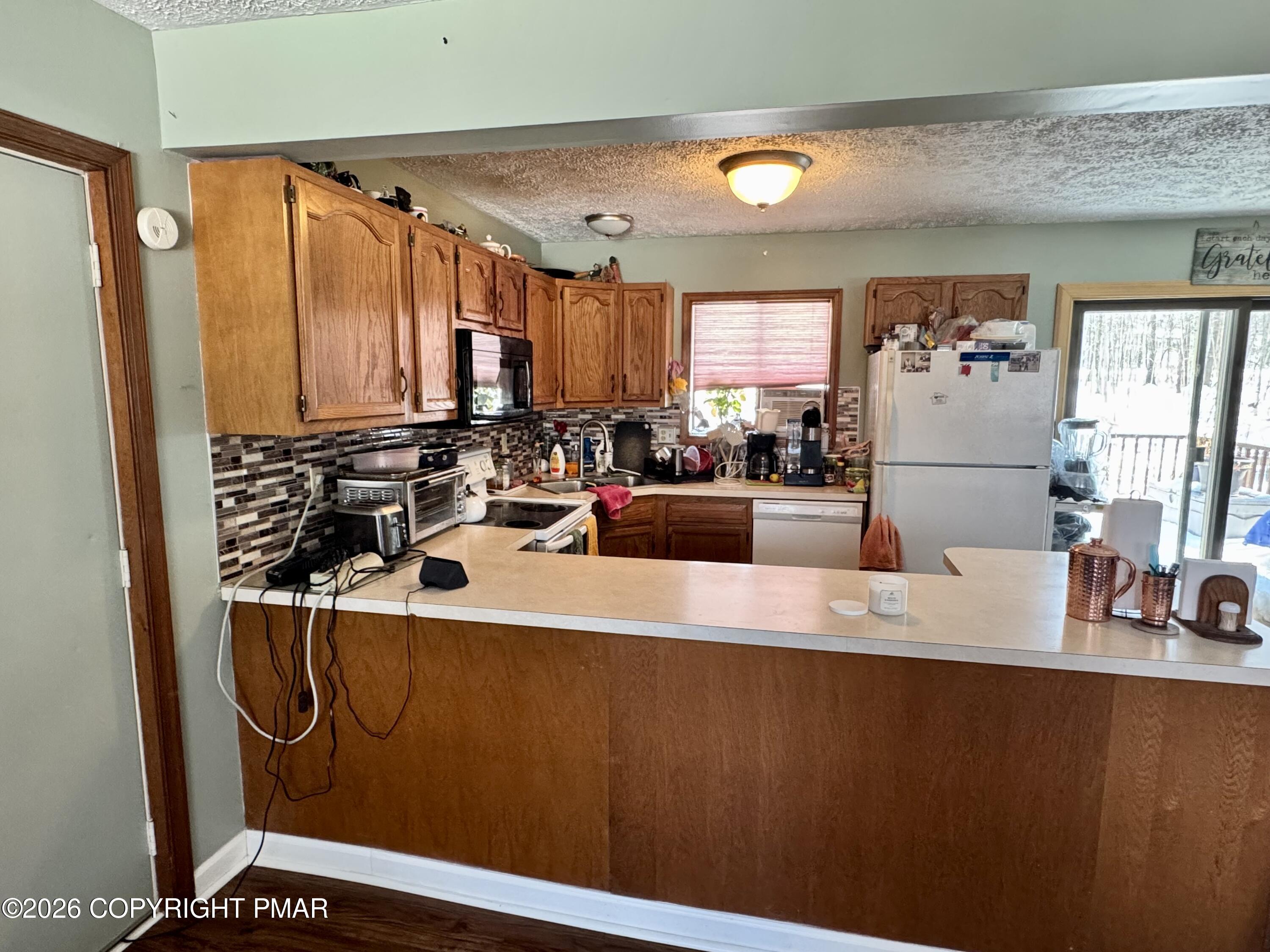 217 Bindale Road Tamiment, PA 18371 - Photo 4 of 27 a view of a kitchen with a large window