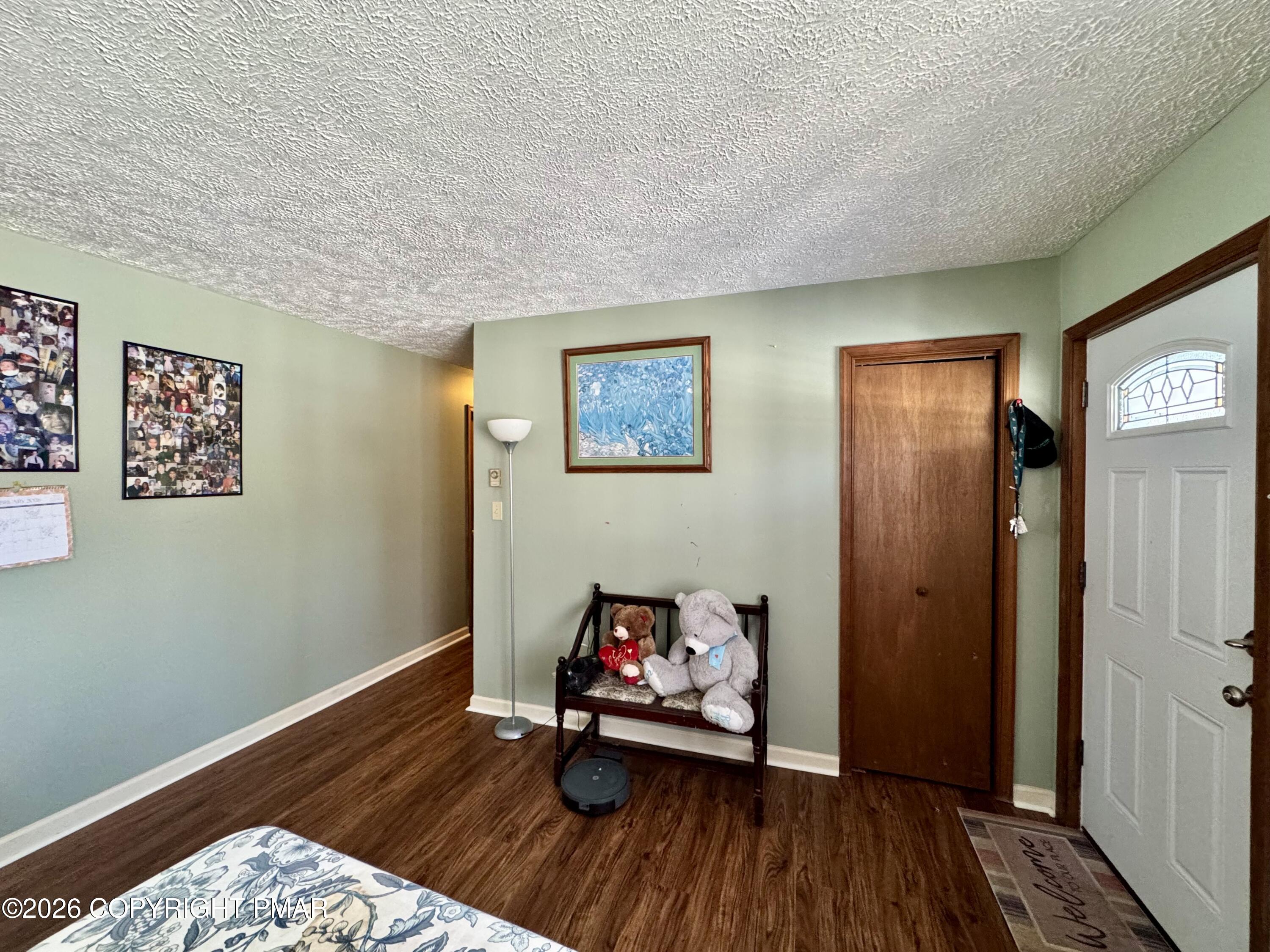 217 Bindale Road Tamiment, PA 18371 - Photo 5 of 27 a way to bedroom with wooden floor and a ceiling fan