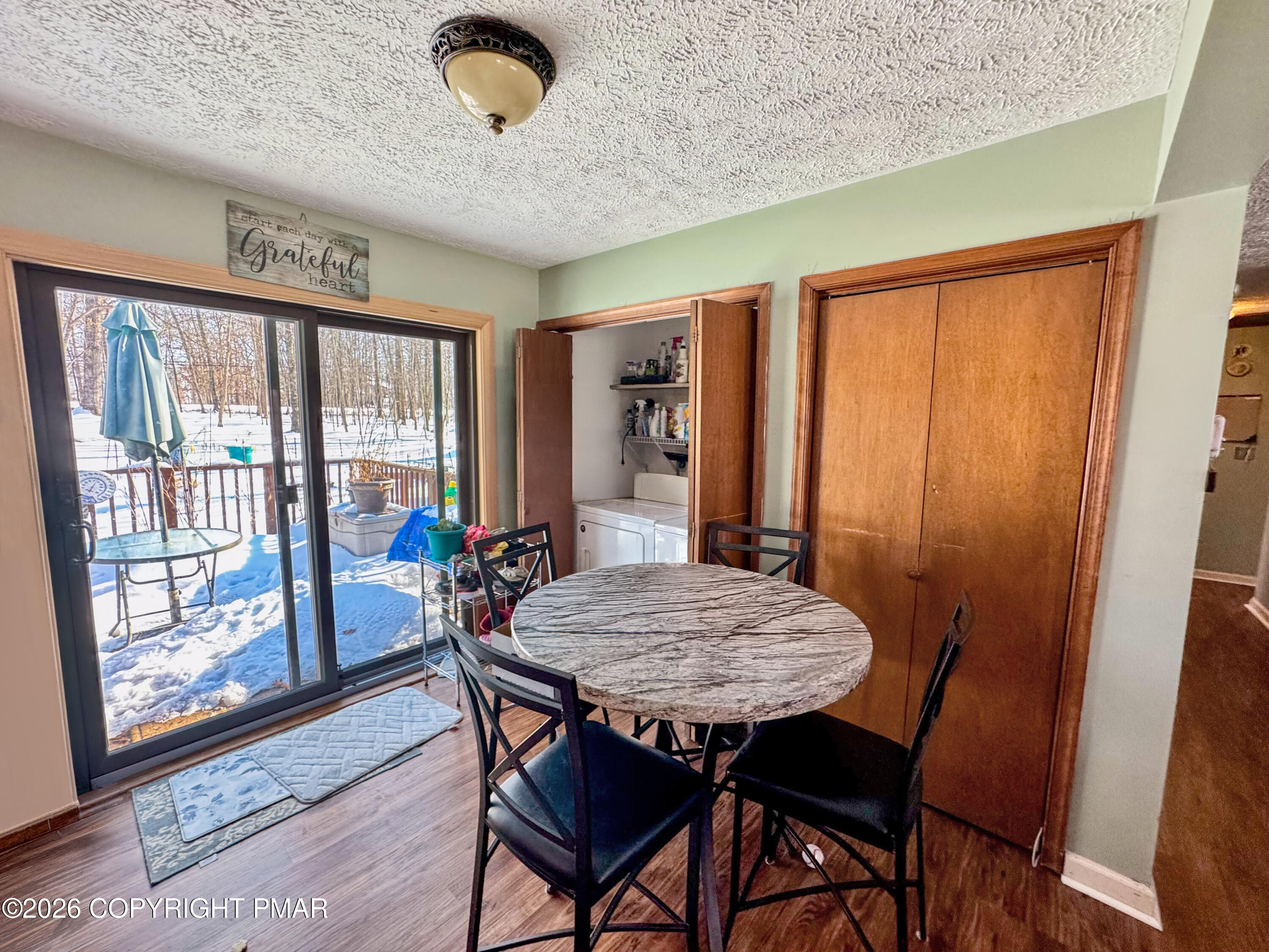 217 Bindale Road Tamiment, PA 18371 - Photo 8 of 27 a view of a dining room with furniture window and wooden floor