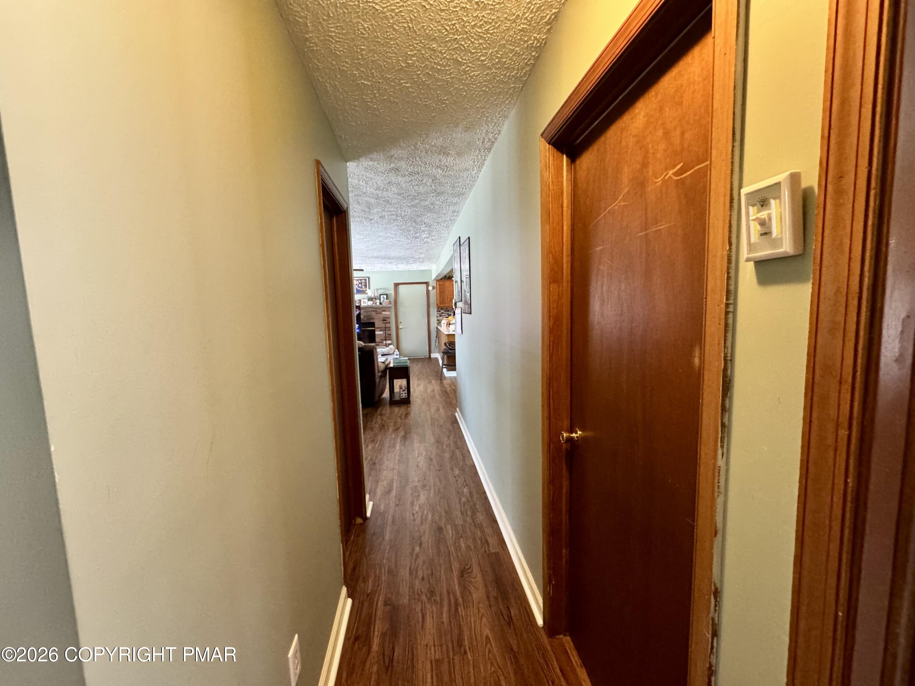 217 Bindale Road Tamiment, PA 18371 - Photo 10 of 27 a view of a hallway with wooden floor and staircase