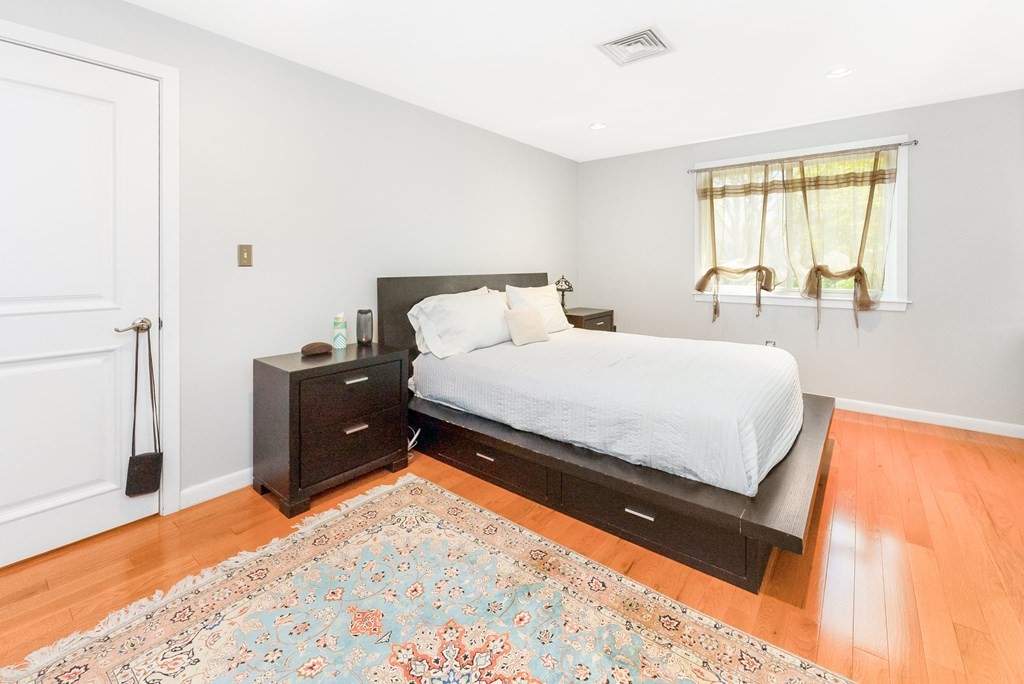 37 River Ridge Wellesley, MA 02481 - Photo 17 of 33 a bedroom with a bed window and a lamp on desk