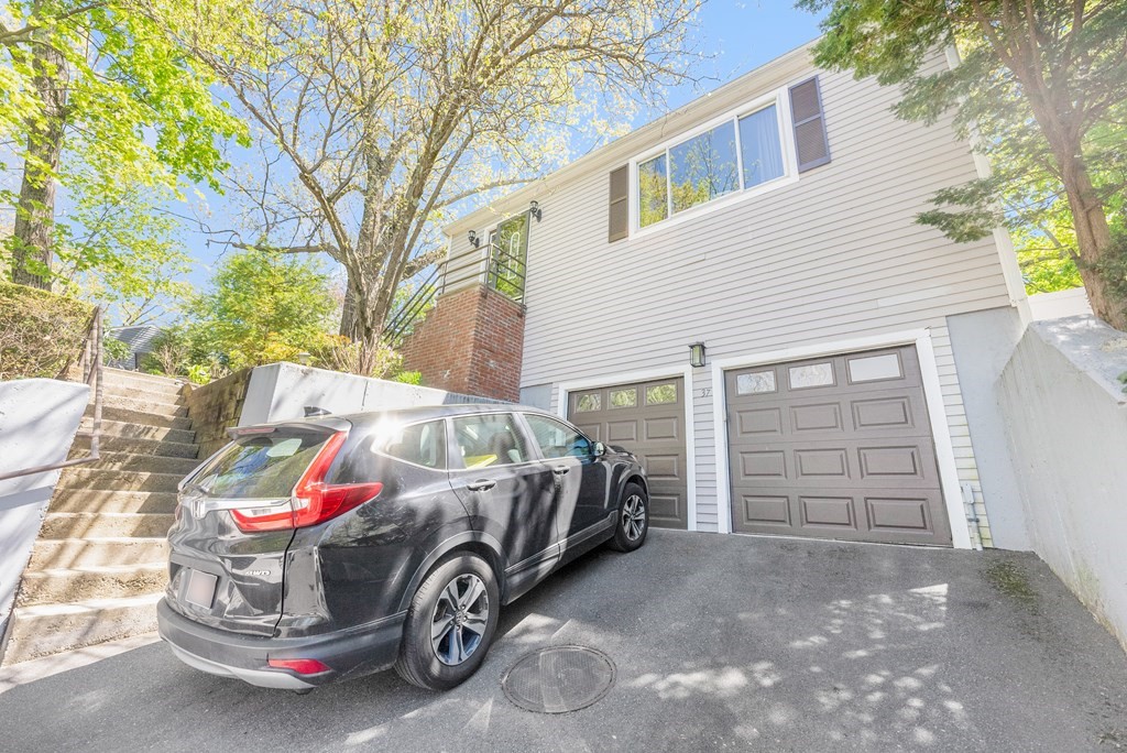 37 River Ridge Wellesley, MA 02481 - Photo 31 of 33 a car parked in front of white house