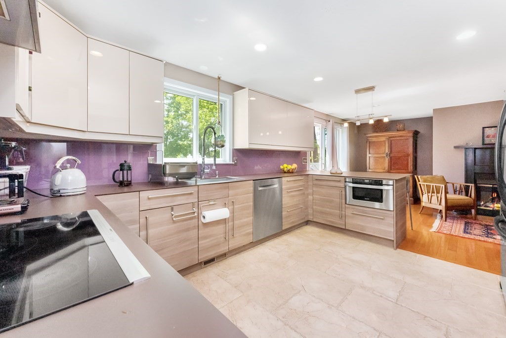 37 River Ridge Wellesley, MA 02481 - Photo 10 of 33 a kitchen with stainless steel appliances granite countertop a stove sink and cabinets
