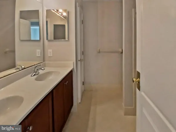 a bathroom with a double vanity sink a and mirror