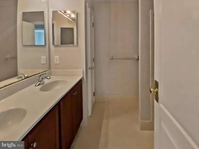 a bathroom with a double vanity sink a and mirror