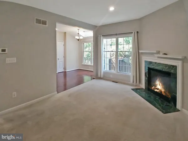 a view of a livingroom with a fireplace and window