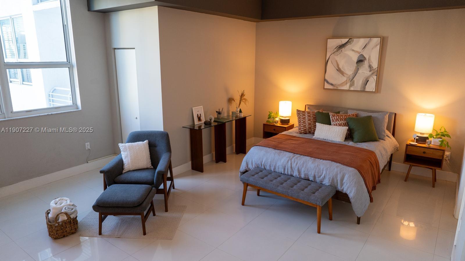 133 Northeast 2nd Avenue, Unit 3308 Miami, FL 33132 - Photo 12 of 14 a bedroom with bed and chair