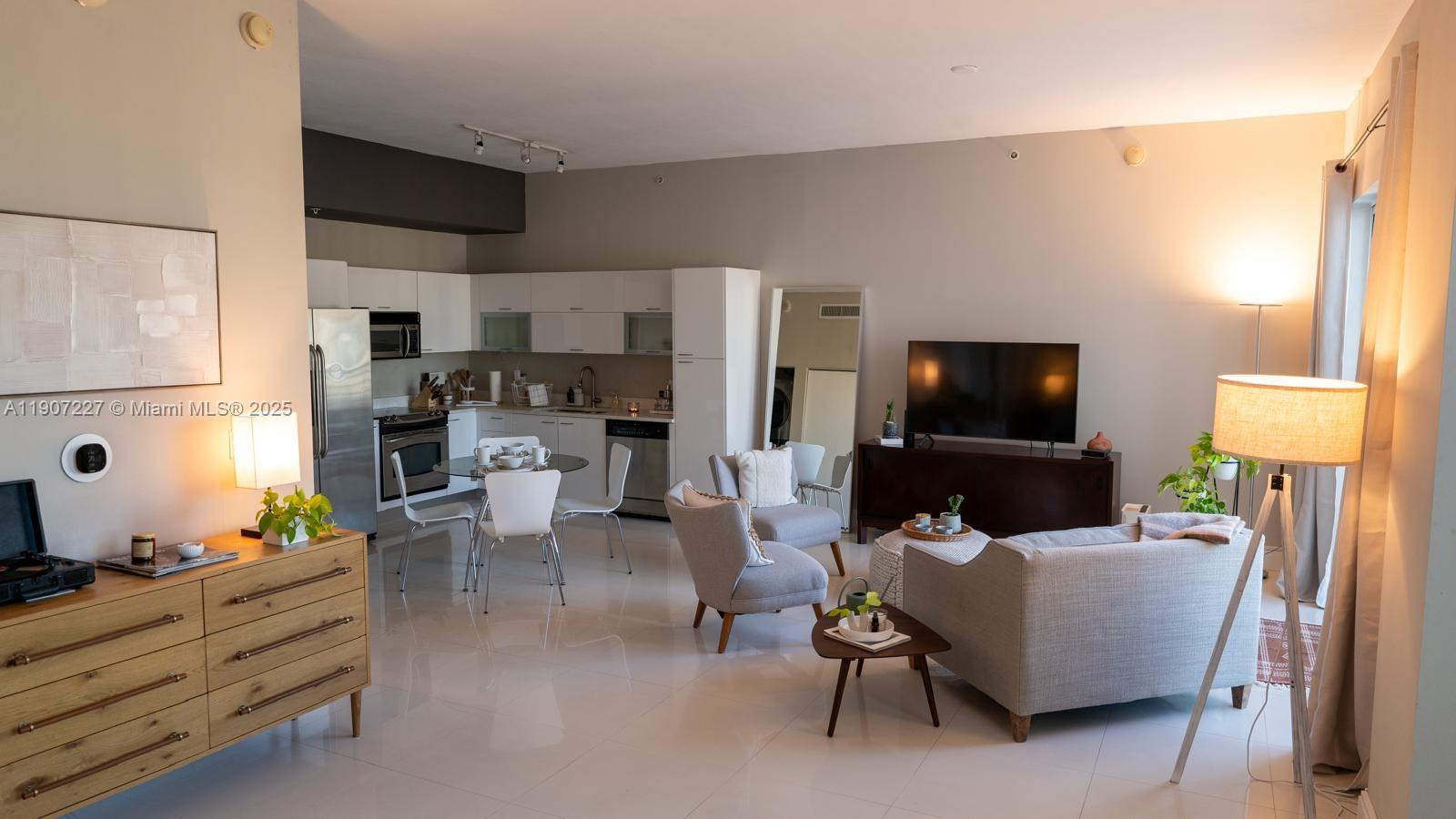 133 Northeast 2nd Avenue, Unit 3308 Miami, FL 33132 - Photo 6 of 14 a living room with furniture and a flat screen tv