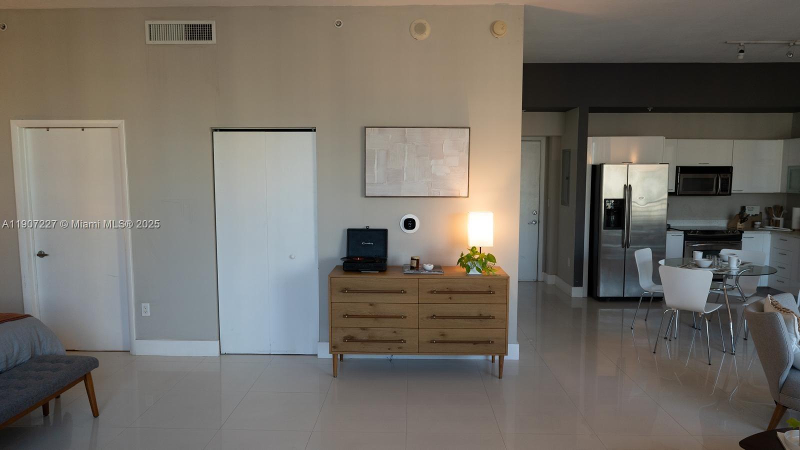133 Northeast 2nd Avenue, Unit 3308 Miami, FL 33132 - Photo 7 of 14 a room with furniture and a wooden floor