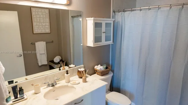 a bathroom with a sink toilet and shower
