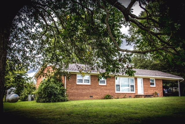 1143 Rabbit Trail Road Five Points, TN 38457 - Photo 2 of 13 a front view of a house with a garden