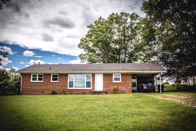 1143 Rabbit Trail Road Five Points, TN 38457 - Photo 7 of 13 a view of a yard in front of a house with a large tree