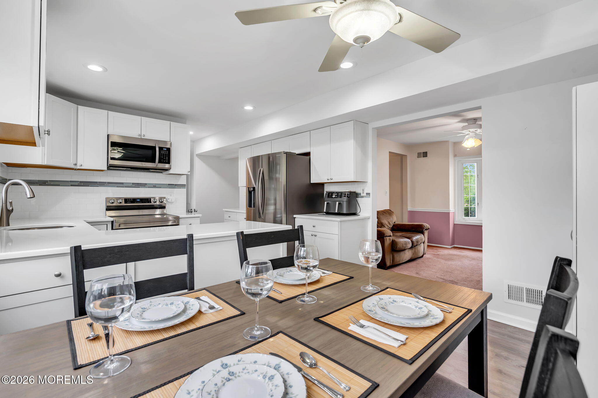 96 Yellowbank Road Toms River, NJ 08753 - Photo 12 of 45 a kitchen with a table chairs stove and refrigerator
