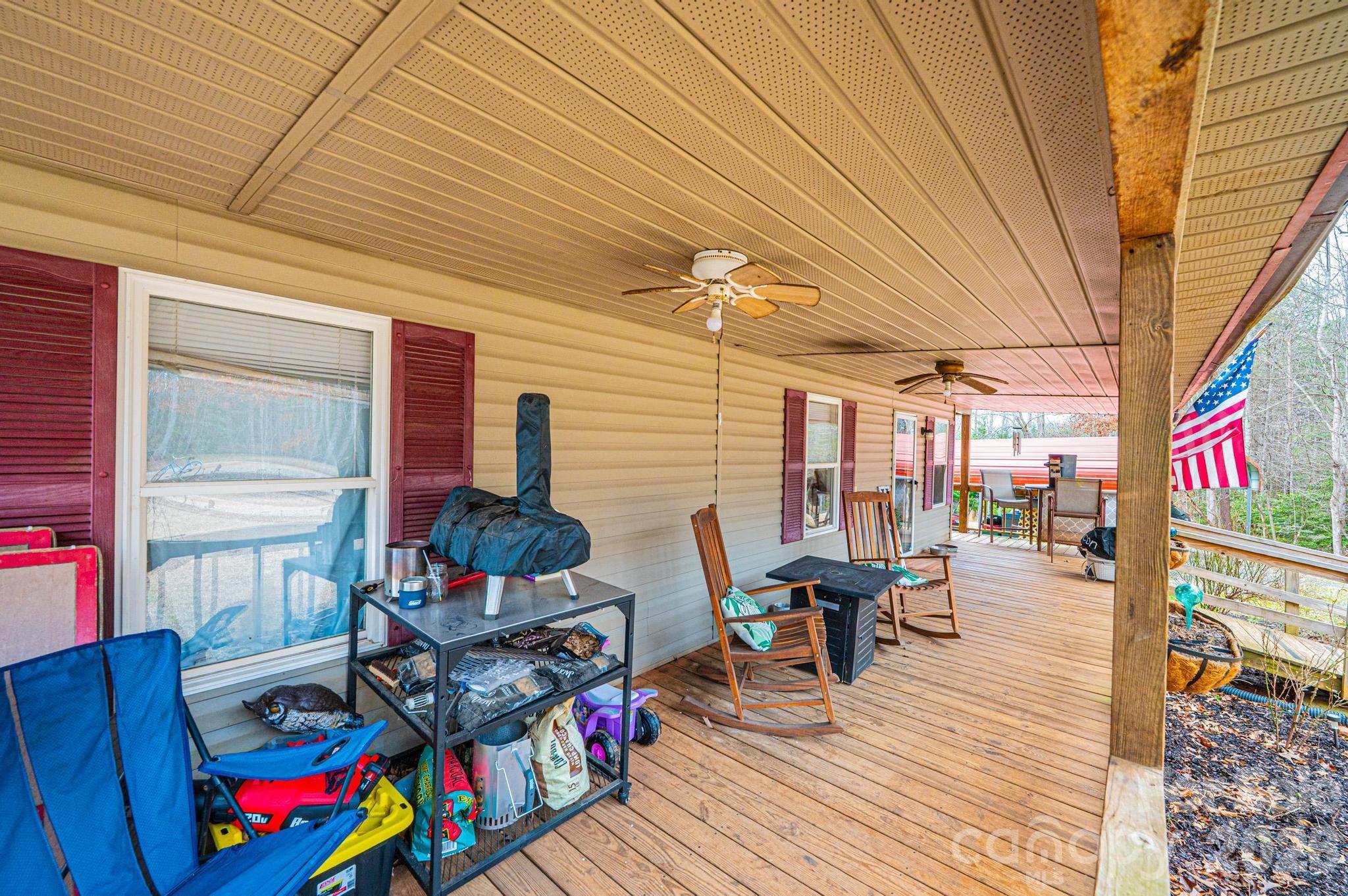 173 Croom Hollow Road Nebo, NC 28761 - Photo 18 of 43 a view of a patio with table and chairs potted plants and wooden floor