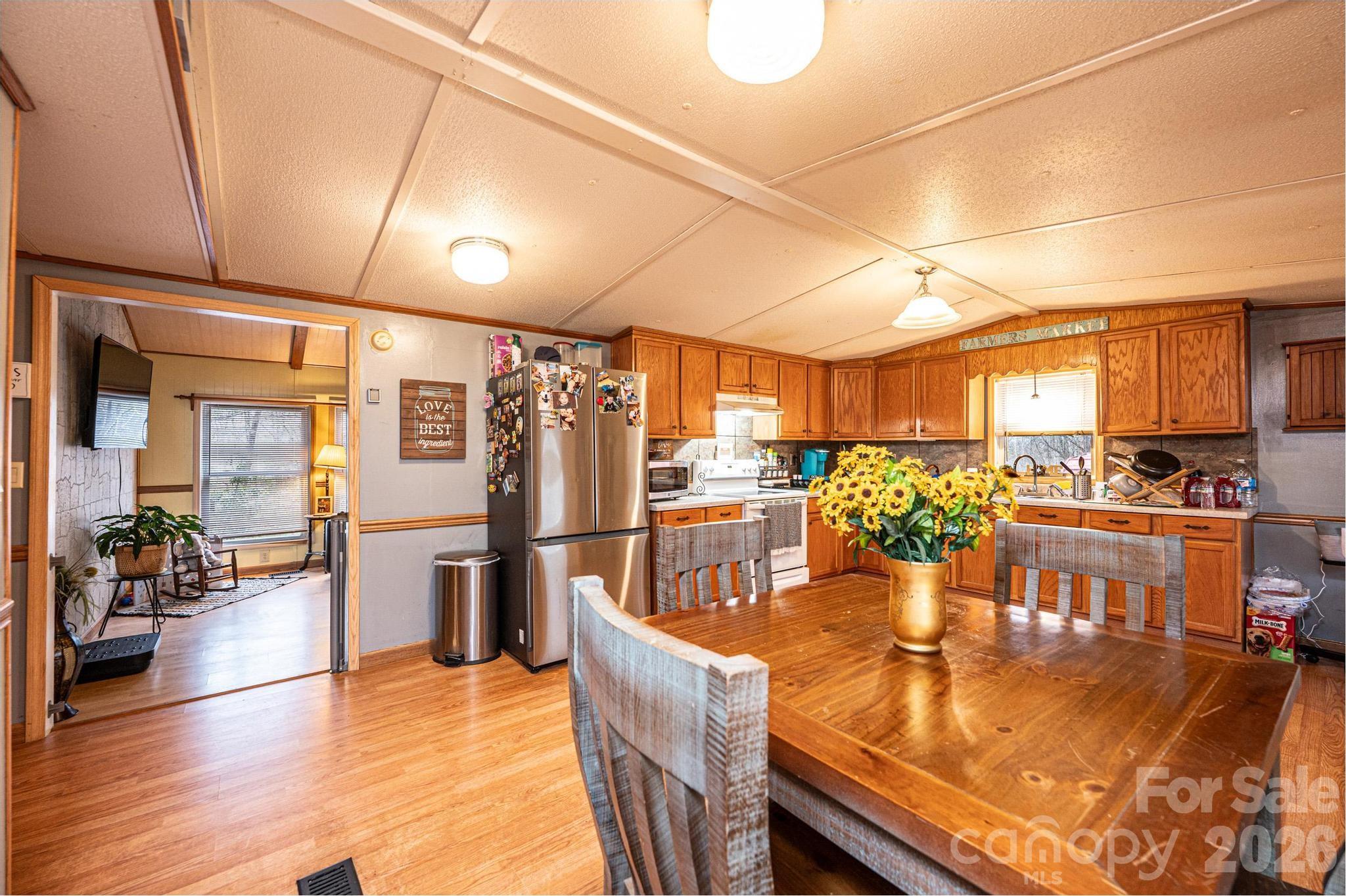 173 Croom Hollow Road Nebo, NC 28761 - Photo 22 of 43 a dining room with stainless steel appliances lots of wooden furniture