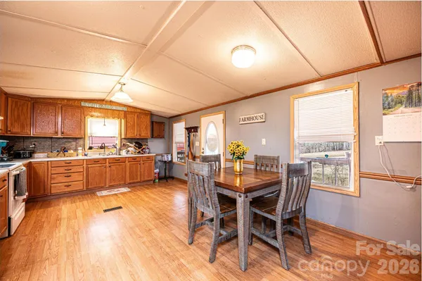 a large kitchen with a table and chairs