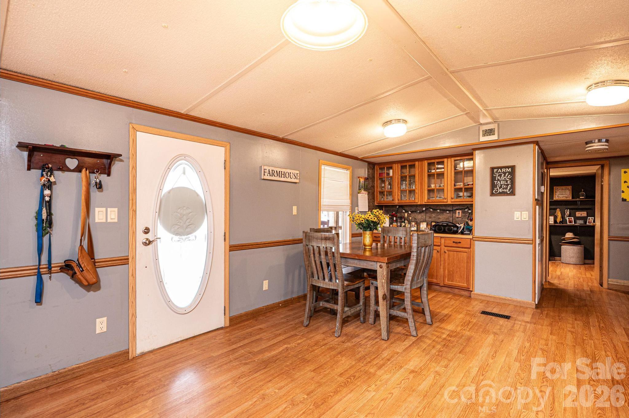 173 Croom Hollow Road Nebo, NC 28761 - Photo 25 of 43 a dining room with furniture a chandelier and wooden floor