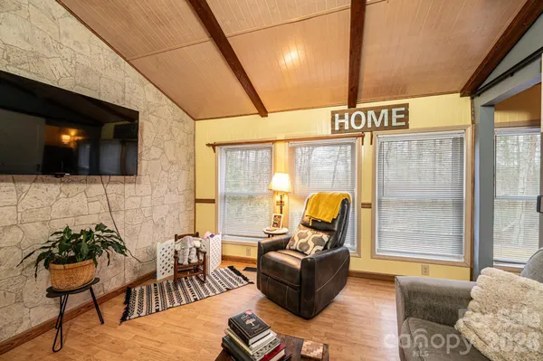 a outdoor living space with furniture and a flat screen tv