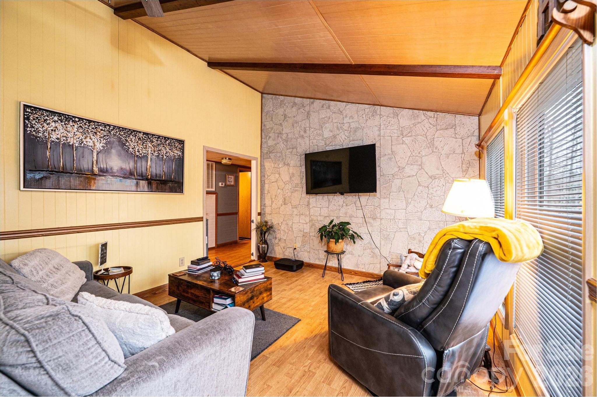 173 Croom Hollow Road Nebo, NC 28761 - Photo 29 of 43 a living room with furniture and a flat screen tv