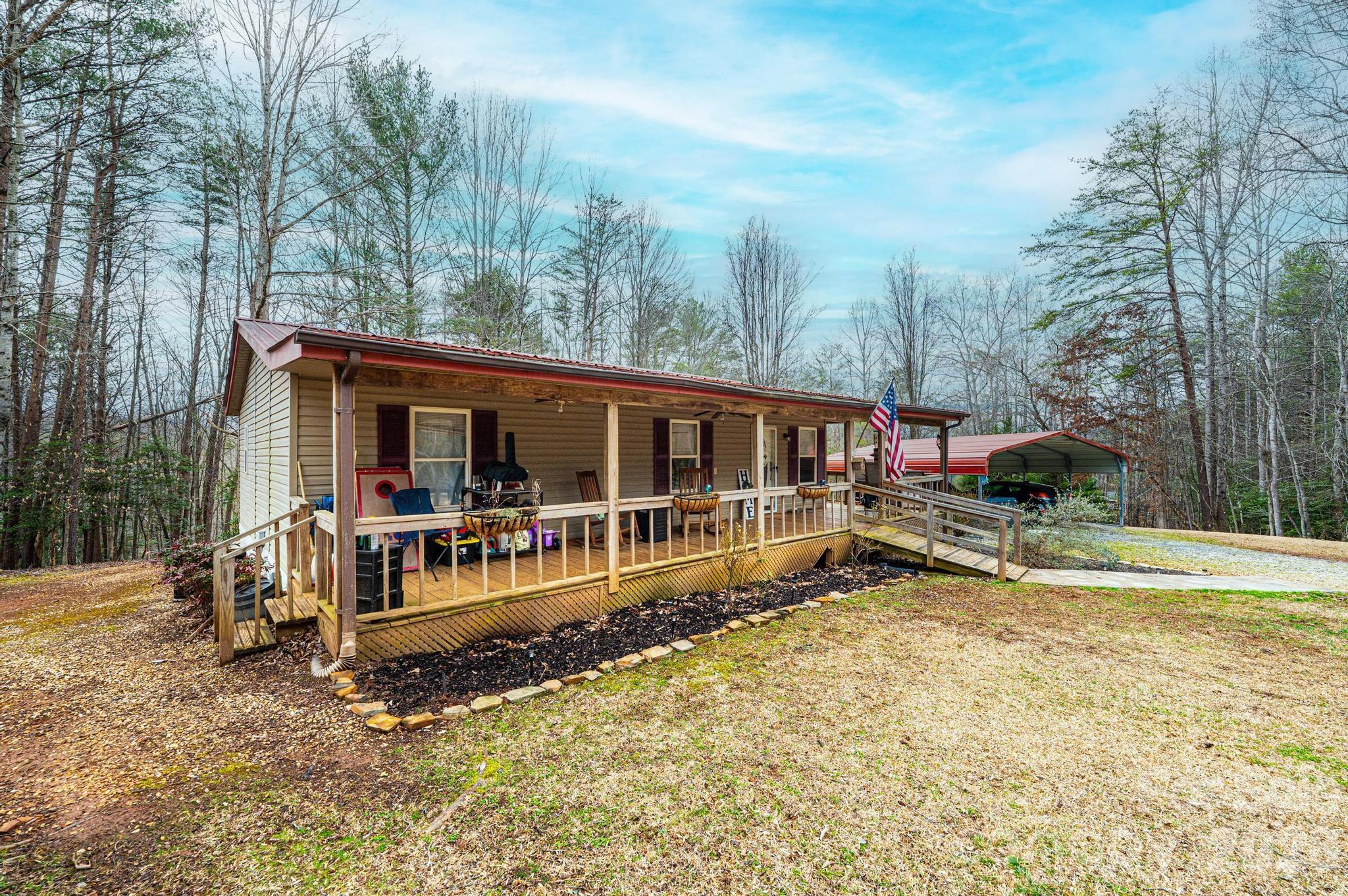173 Croom Hollow Road Nebo, NC 28761 - Photo 3 of 43 a view of a house with a yard and sitting area