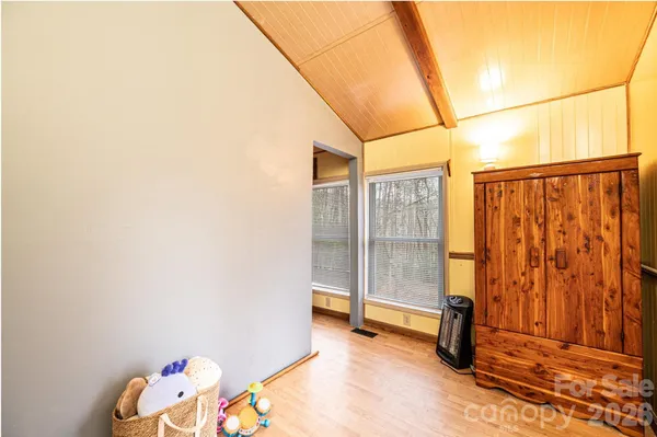 a view of a room with wooden floor and fence