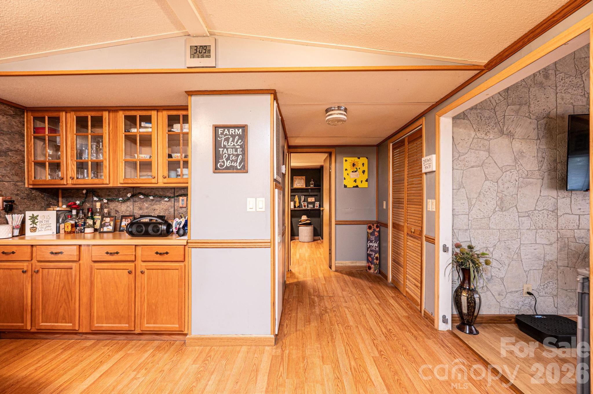 173 Croom Hollow Road Nebo, NC 28761 - Photo 33 of 43 a kitchen with stainless steel appliances granite countertop a refrigerator a stove and a wooden floors