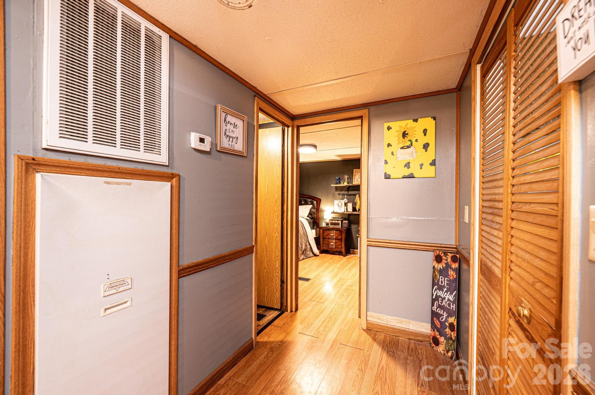 173 Croom Hollow Road Nebo, NC 28761 - Photo 34 of 43 a view of a hallway with wooden floor and a bathroom
