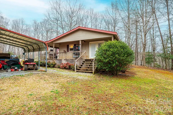 a view of a house with a yard and garage