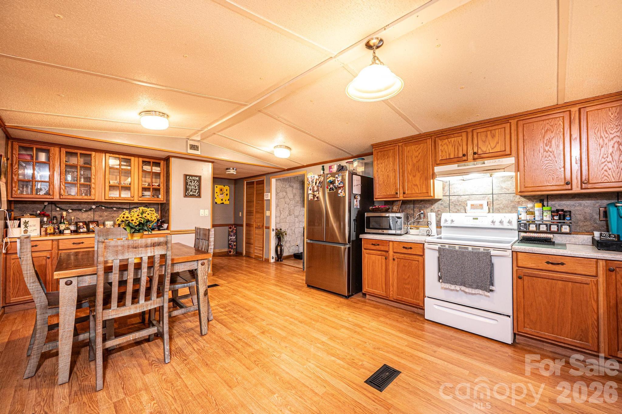 173 Croom Hollow Road Nebo, NC 28761 - Photo 43 of 43 a open kitchen with stainless steel appliances granite countertop a stove and a refrigerator