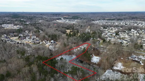 an aerial view of a houses with a yard