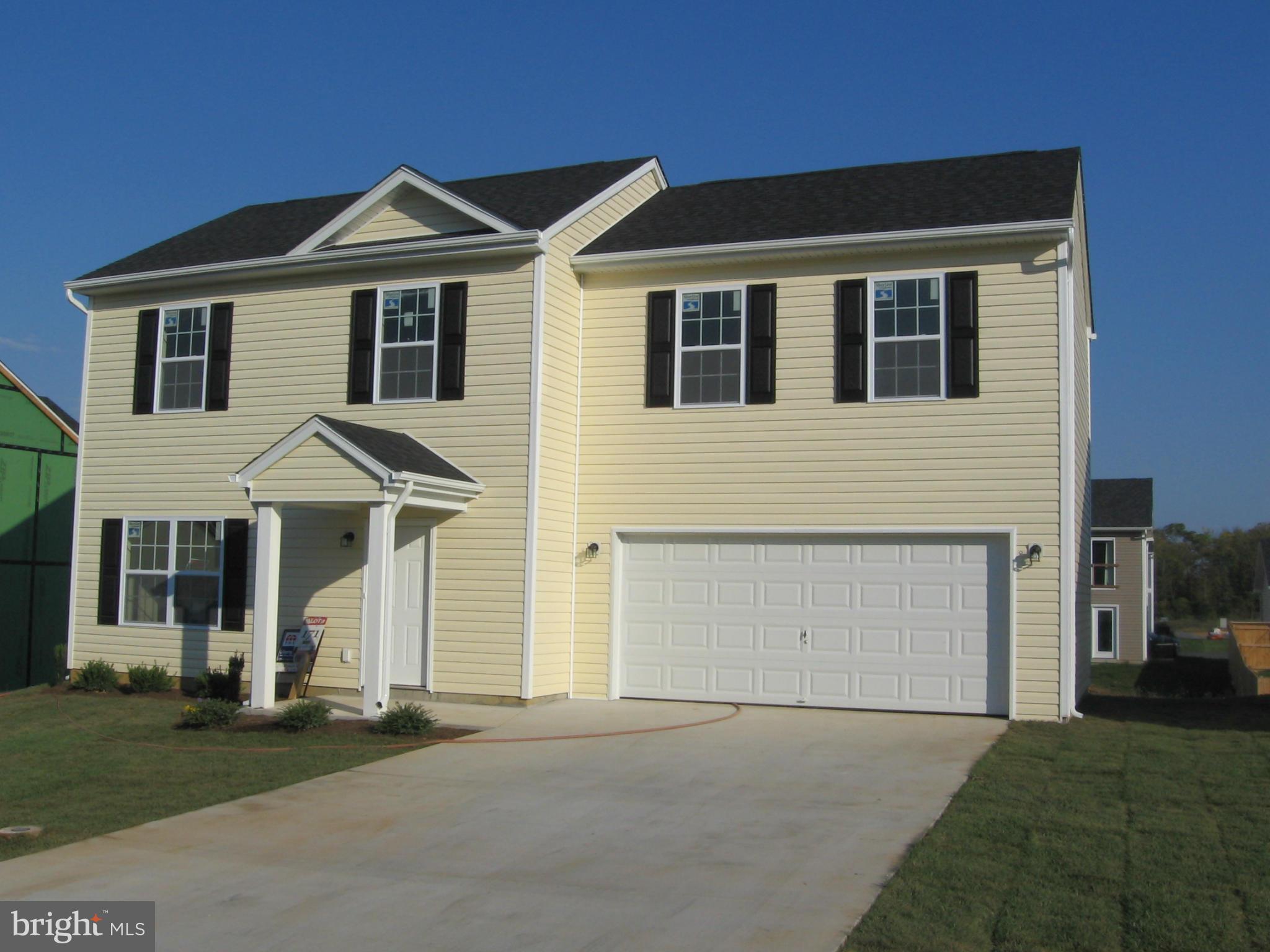 58 Gibson Road Inwood, WV 25428 - Photo 2 of 17 a front view of a house with a yard and garage