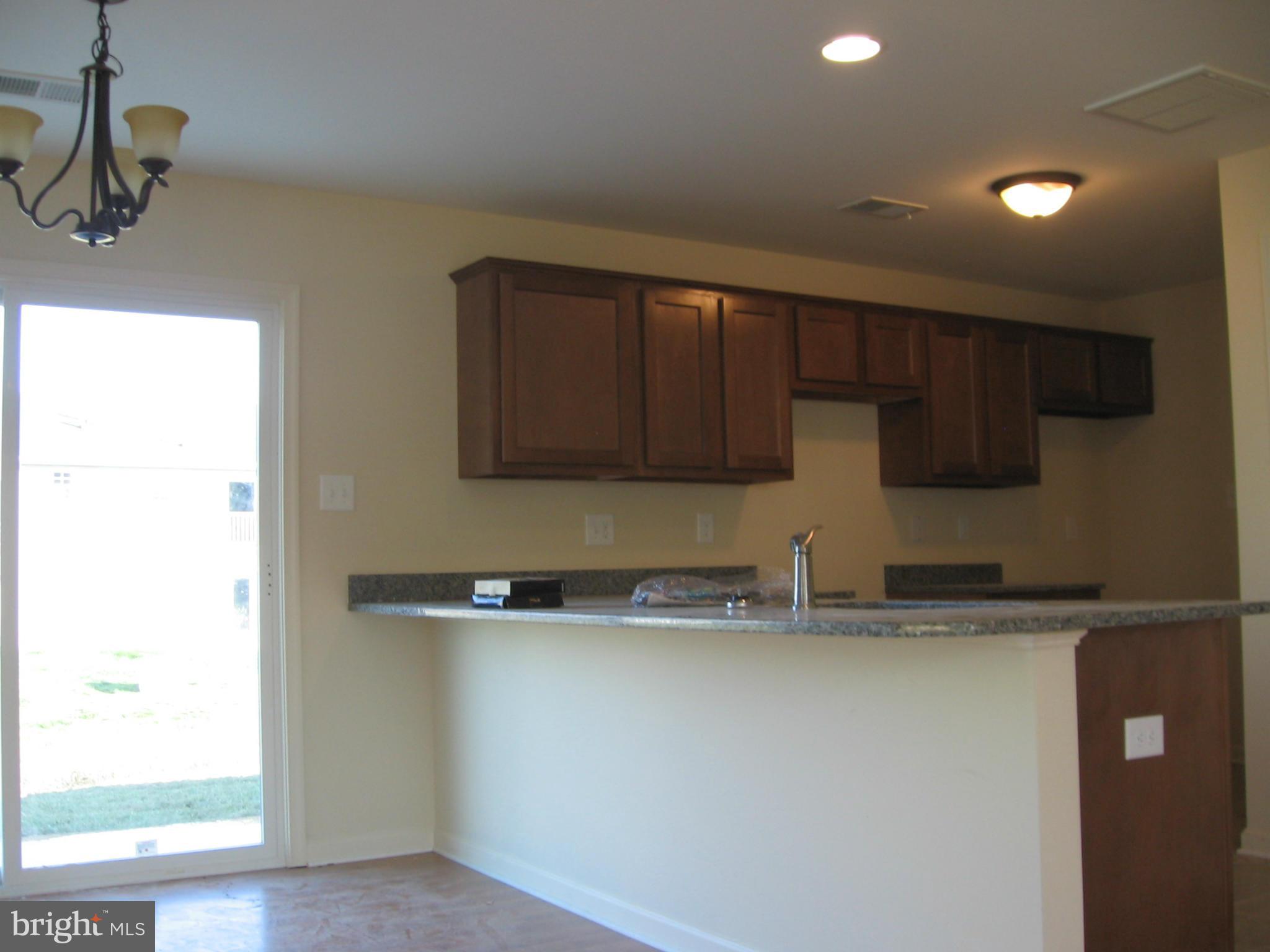 58 Gibson Road Inwood, WV 25428 - Photo 4 of 17 a kitchen with stainless steel appliances granite countertop a sink and a microwave