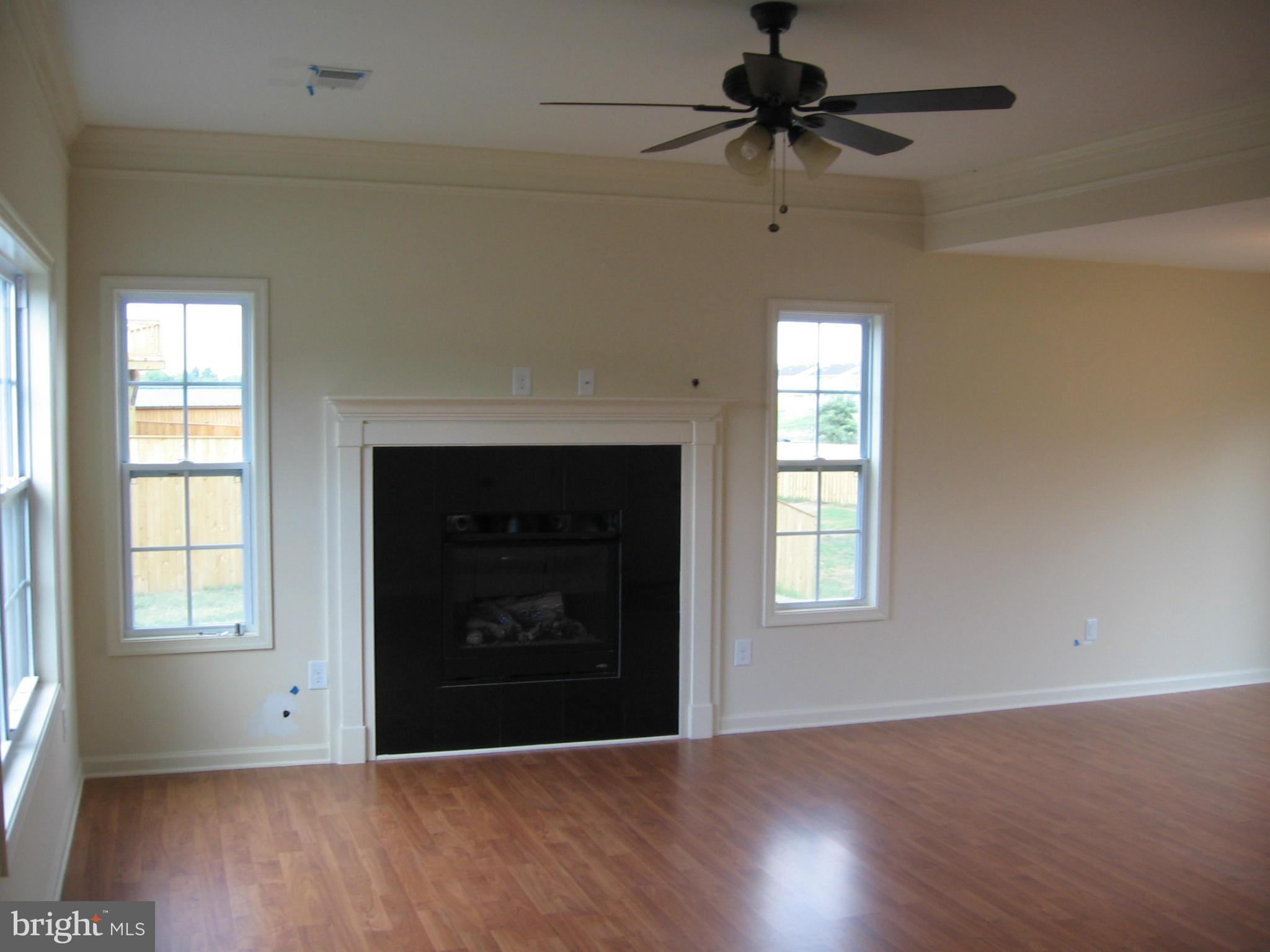 58 Gibson Road Inwood, WV 25428 - Photo 9 of 17 an empty room with windows and a fireplace