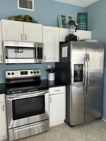 a kitchen with cabinets and stainless steel appliances