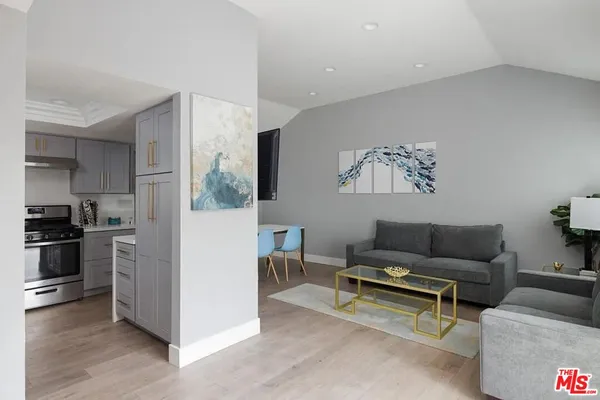 a living room with furniture and a kitchen